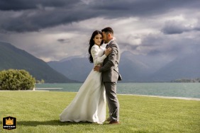   Just before the storm in Annecy, Haute-Savoie, the atmosphere pulses with anticipation, the couple savoring a quiet, dramatic portrait session with darkening skies as their backdrop.
